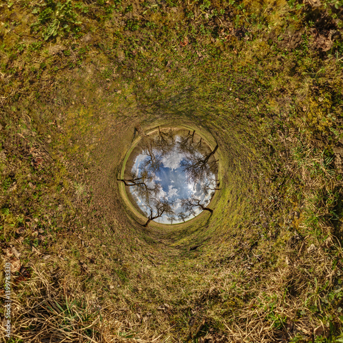 Obraz na płótnie blue hole sphere or globe little planet inside grass or sand or dry ground frame background with tractor tracks w salonie
