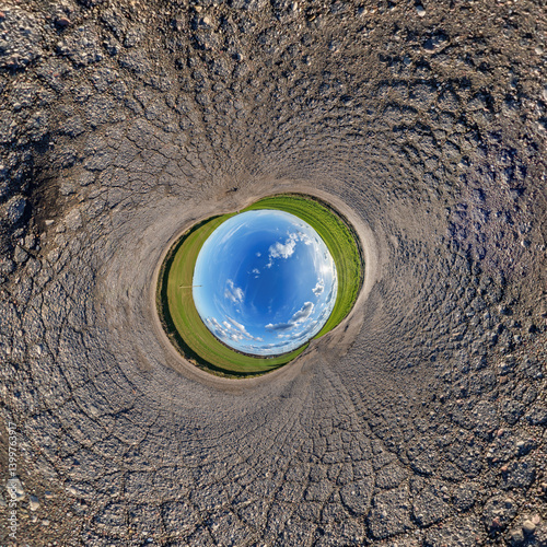 Obraz na płótnie blue hole sphere or globe little planet inside grass or sand or dry ground frame background with tractor tracks w salonie