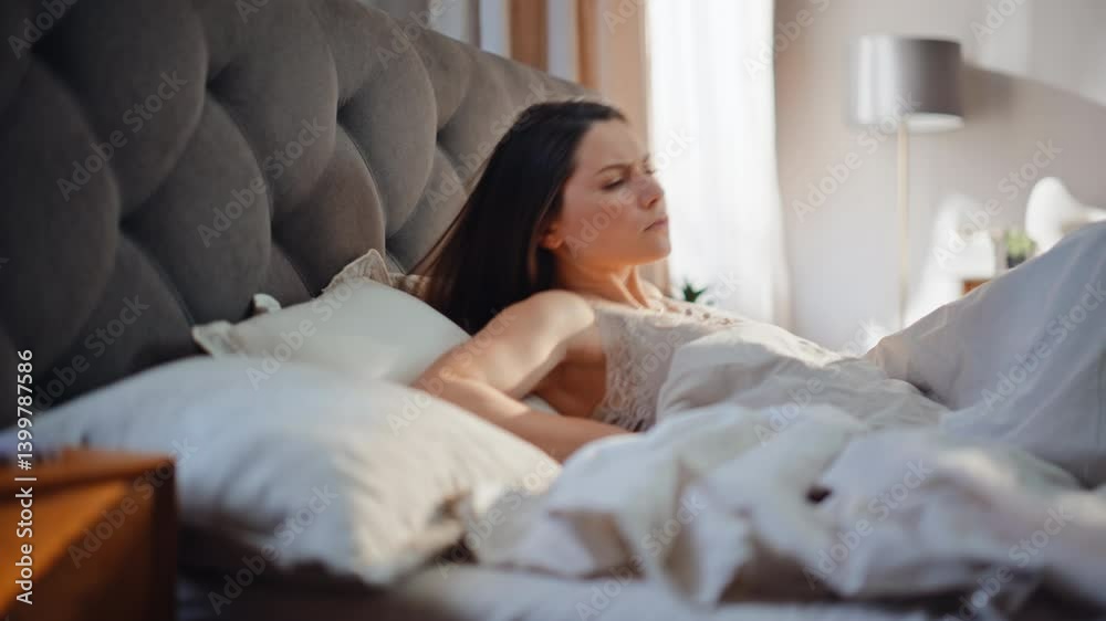 Tired woman waking early morning feeling stomach pain in soft bed closeup. Tired woman waking early morning feeling stomach pain in soft bed closeup.