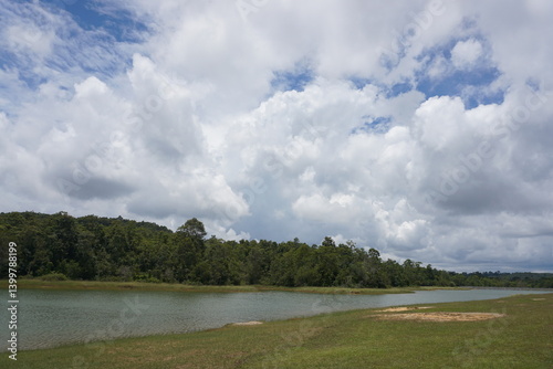 Obraz na płótnie Refreshing riverbank scene lush greenery nature photography cloudy sky tranquil view w salonie