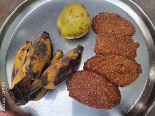 a plat of guava, banana and Thekua. It's commonly offered as prasad during the Chhath Puja festival in Bihar and other regions of India photo