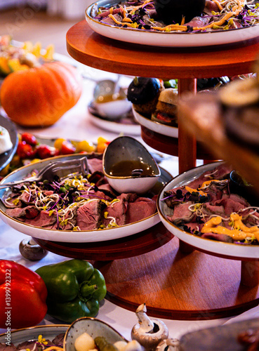 Festive buffet with pumpkins and assorted seasonal dishes.