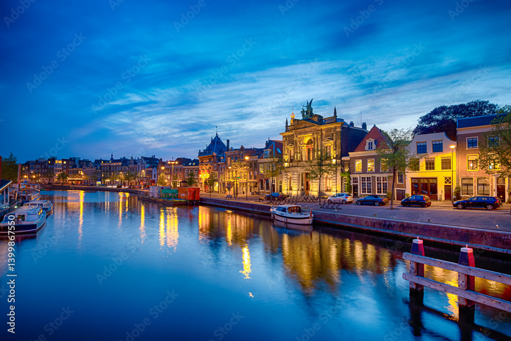 Naklejka premium Travel View of Harlem Sight on Spaarne River On The Background At Twilight.