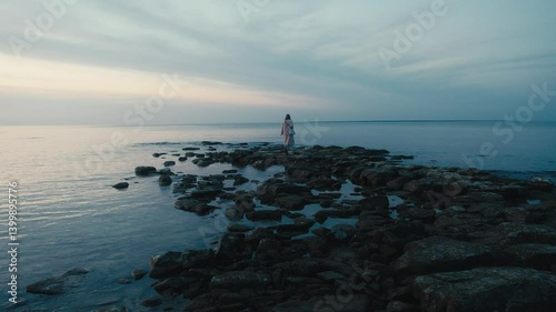 Wallpaper Mural Woman Standing on Rocky Shore at Dusk Torontodigital.ca