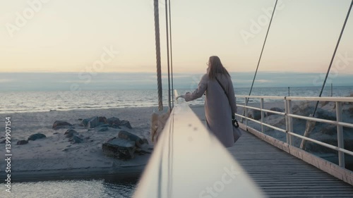 Wallpaper Mural Woman Walking on Bridge Over Water at Sunset Torontodigital.ca