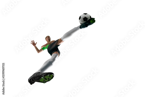 Obraz na płótnie Low angle of young soccer player sprinting with ball, face focused, power in every step against white studio background. Concept of professional sport, training, tournament, energy. Ad w salonie
