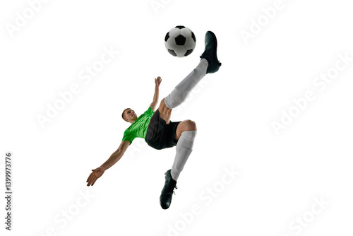 Low angle of strong man, dressed sport uniform, soccer player leaping for bicycle kick against white studio background. Concept of professional sport, training, tournament, energy. Ad