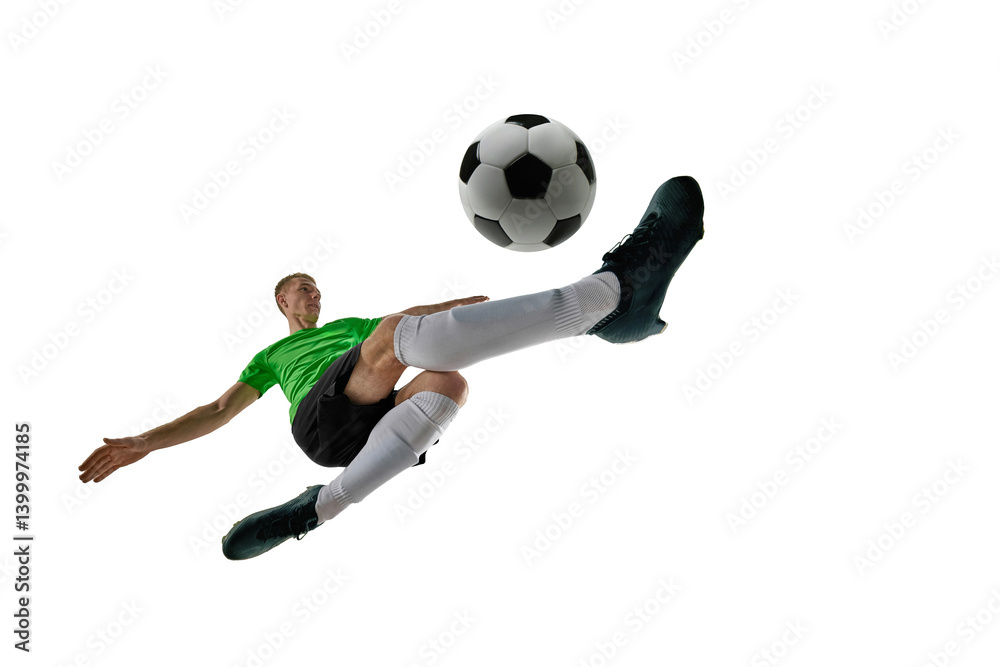 Low angle of focused man, dressed sport uniform, soccer player defending goal with tackle against white studio background. Concept of professional sport, training, tournament, energy. Ad