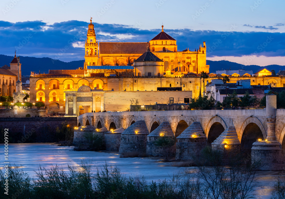Mezquita (Great Mosque of Cordoba) and Roman bridge at sunset, Spain