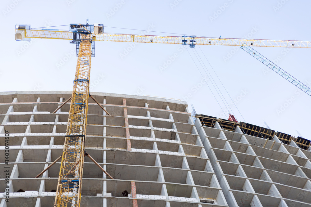 High-rise building under construction with cranes