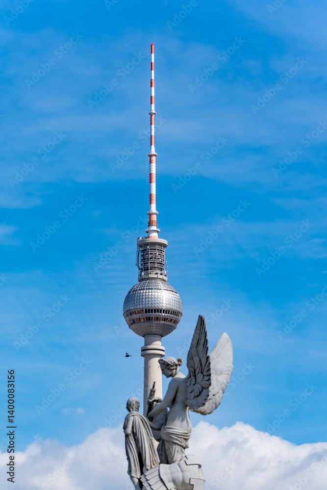 The Berlin TV Tower is located against the blue sky. Berlin Tower close-up. The Berlin TV Tower is located against the blue sky. Berlin Tower close-up.