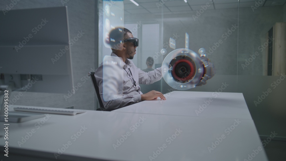 Obraz premium African American Engineer Uses Augmented Reality Headset to Visualize 3D Holographic Model of Renewable Energy Engine. Virtual Visualization of Design Software Based on Artificial Intelligence.