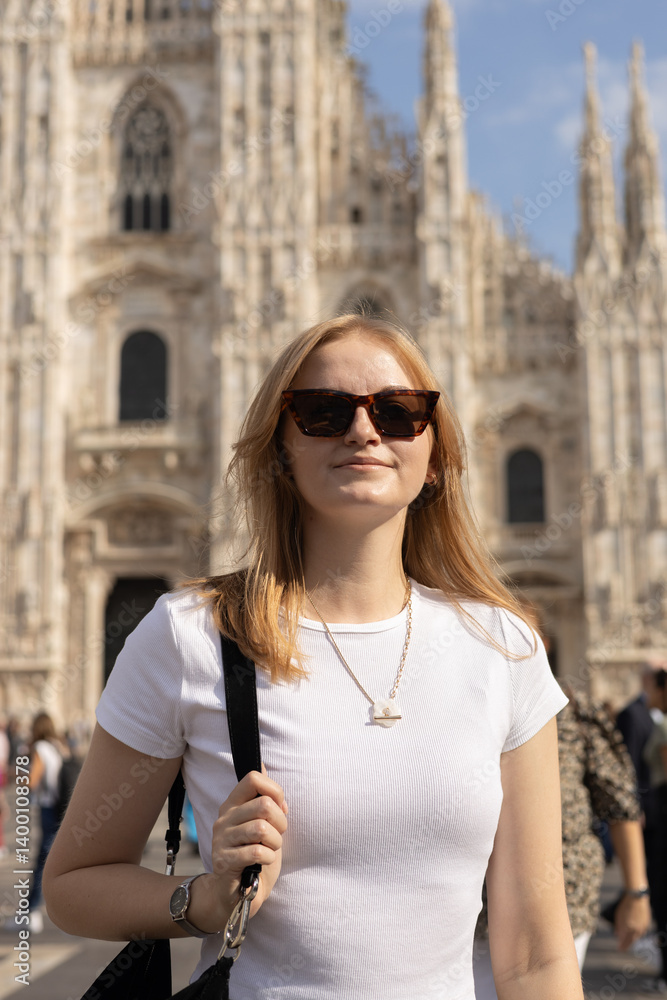 Portrait of attractive 30s woman in sunglasses in Milan Cathedral Square, Italy. Concept of tourism, love to travel