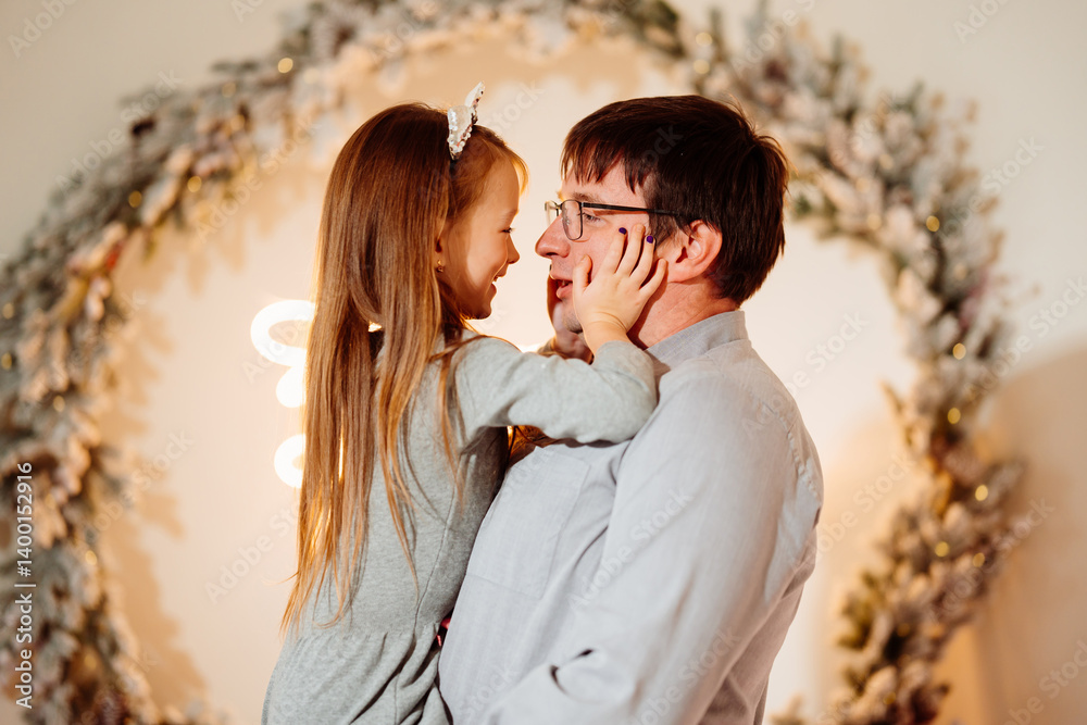 Happy dad and daughter in christmas decor.