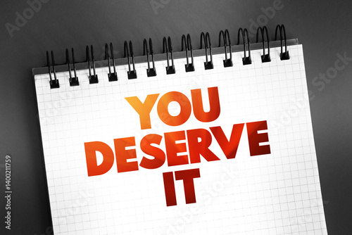 You Deserve It text on notepad, concept background photo