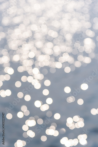 Circular light spots on the water surface. The river in bokeh. Dreamy blue background.