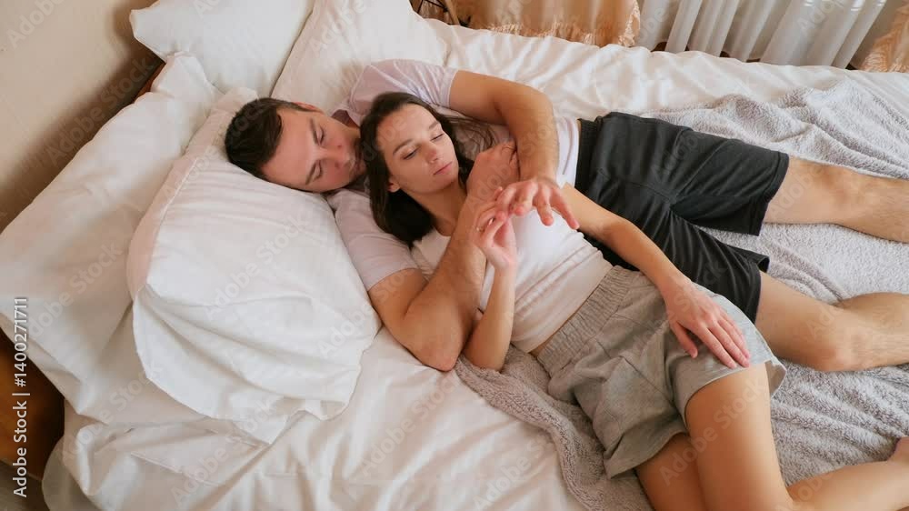 Loving couple relax in the comfortable bed in the bedroom