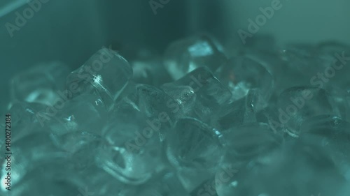Heap of blue crystal ice cubes in container