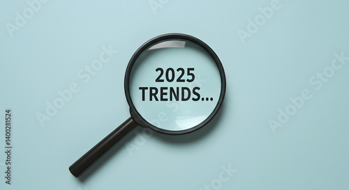 Trends 2025 year concept. Hand holding magnifying glass with 2025 trend searching bar for optimization 2025 business marketing trends and business plan