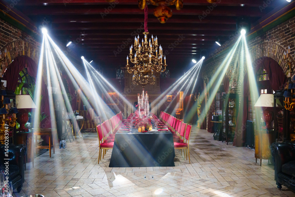 Spotlights in the banquet hall of a dark restaurant.
