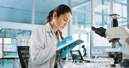Scientist, woman and tablet with digital notes for biology, innovation or medical research analysis. Biotech, laboratory and thinking with DNA study for pharmaceutical RNA or pathology experiment
