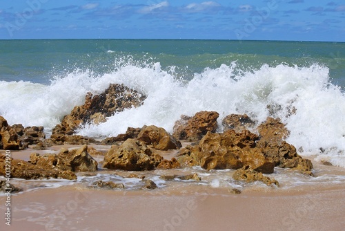 White foam on the air, sea water splashing when  crashing rock on the beach. Coqqueiros beach near Joao Pessoa, Brazil northeast. 