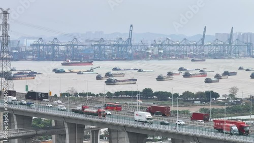 Multi-level bridge China. Cars drive transport interchange. Road traffic. Chinese ship sails, freight cargo logistic. Aerial top drone view, fast urban highway. Modern city freeway. Shipping delivery.