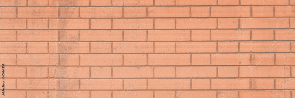 Red brick wall texture. The decorative plaster imitating a bricklaying and the socle revetted with a stone. Background brickwork.