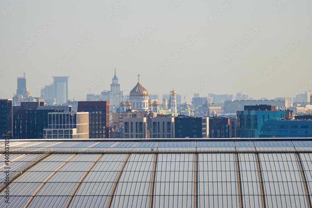 Panorama of the city of Moscow. Beautiful cityscape. In the foreground is the roof of the stadium, in the distance is the Cathedral of Christ the Savior and high-rise buildings. Moscow, Russia.