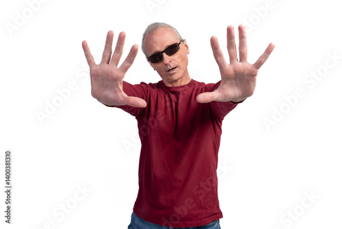 Senior man showing stop sign with hands, expressing refusal