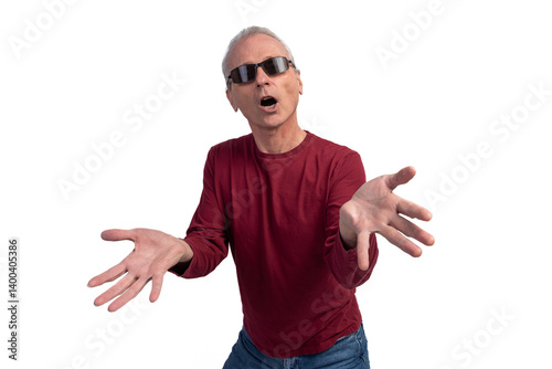 Confused senior man shrugging with open arms and sunglasses