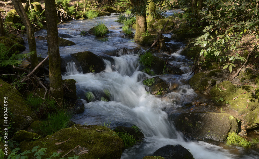 Mountain river with motion blur, nature, and small waterfall, Santo Tirso, Portugal Mountain river with motion blur, nature, and small waterfall, Santo Tirso, Portugal