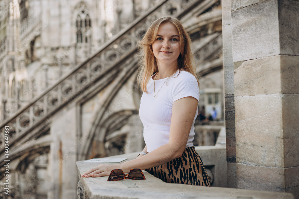 Female traveler standing on the rooftop of Duomo cathedral in Milan. Having great vacations in Milan