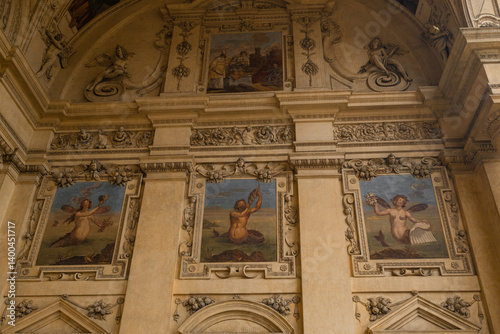 Obraz na płótnie Close-up of beautifully painted frescoes on the walls of an ancient building, showcasing intricate details of historical art. The vibrant colors and craftsmanship highlight the cultural heritage. w salonie