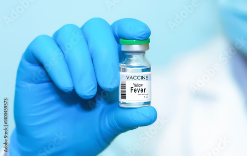 Obraz na płótnie Doctor wearing protective gloves holding a Yellow Fever vaccine bottle, symbolizing modern healthcare, disease prevention, scientific research, immunization, vaccination awareness. Banner, copy space w salonie