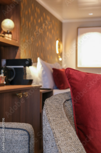 Obraz na płótnie Luxurious mini suite stateroom cabin room onboard luxury cruise ship cruiseship ocean liner with bedroom and living area in red and creme with wood in modern Art Deco interior design w salonie