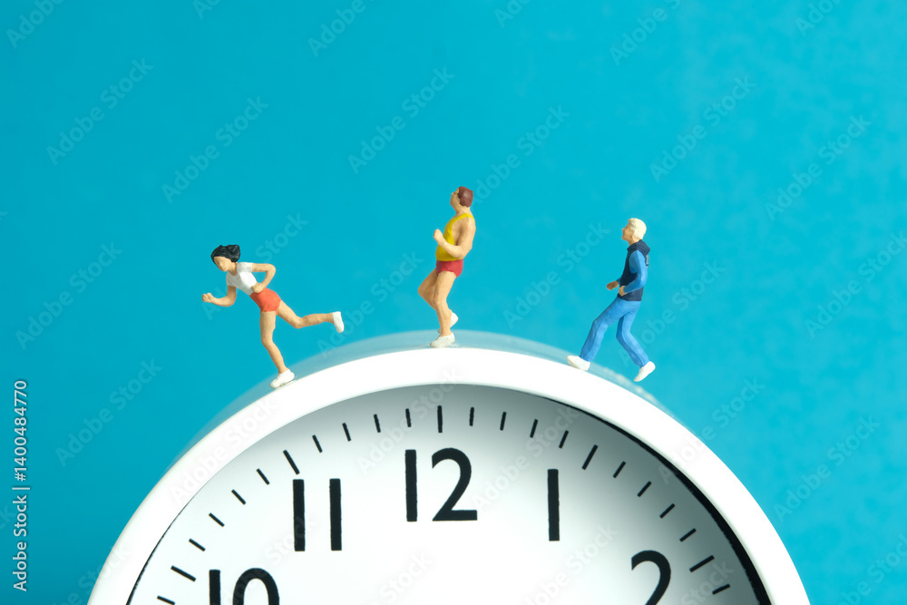 Fototapeta premium Miniature people toy figure photography. Running daily routine concept. A team group runner jogging above clock, isolated on blue background