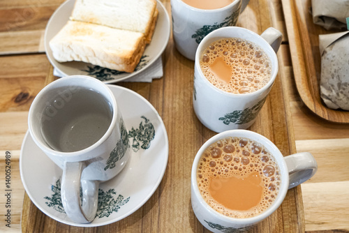 Popular drink in Malaysia called Teh Tarik. It is a sweet drink made from tea with milk. Fractal on the cup is generic print.