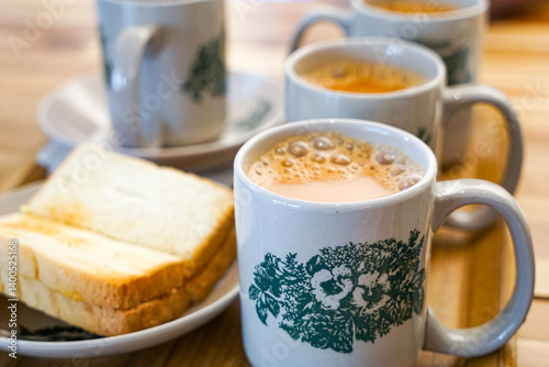 Popular drink in Malaysia called Teh Tarik. It is a sweet drink made from tea with milk. Fractal on the cup is generic print.