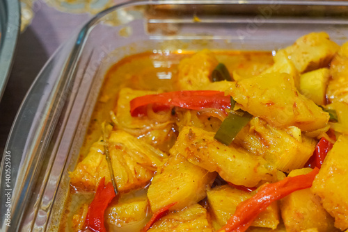 A rich, golden pineapple curry with thick, spiced coconut gravy, sweet, tangy, and aromatic, usually eaten with nasi beriani or nasi minyak for special occasion in Malaysia.  Close up. photo