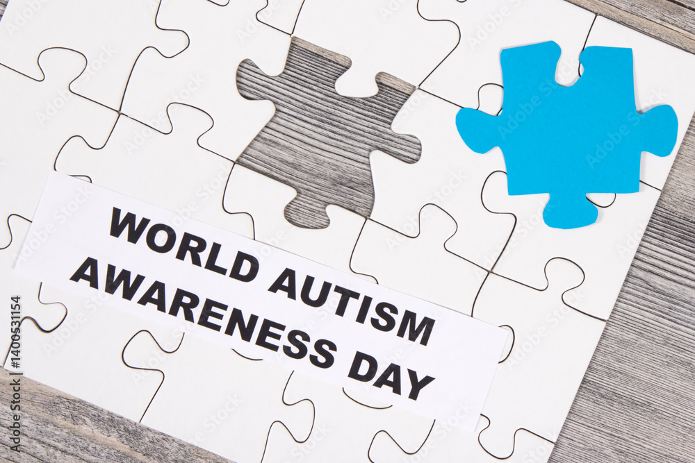 White and blue puzzle. Inscription World Autism Awareness Day. Symbol of Autism Spectrum Disorder White and blue puzzle. Inscription World Autism Awareness Day. Symbol of Autism Spectrum Disorder