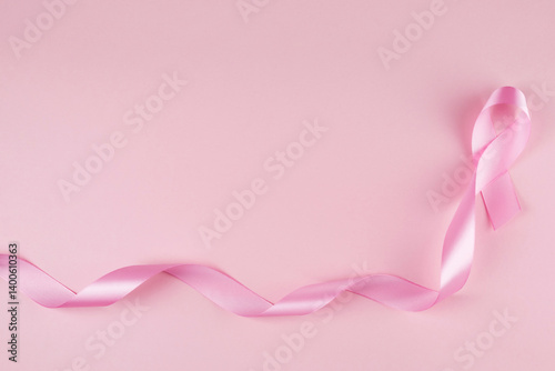 Pink breast cancer awareness ribbon with copy space, pink backgrounnd