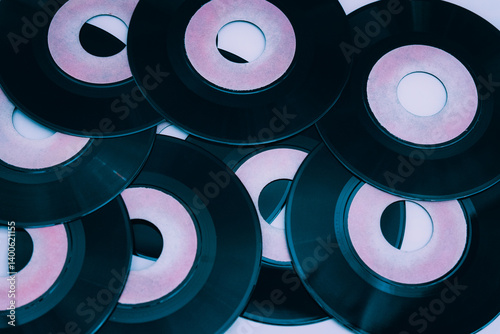 Many vintage vinyl records with pink labels are creating a nostalgic and retro musical background