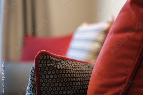 Luxurious mini suite stateroom cabin room onboard luxury cruise ship cruiseship ocean liner with bedroom and living area in red and creme with wood in modern Art Deco interior design