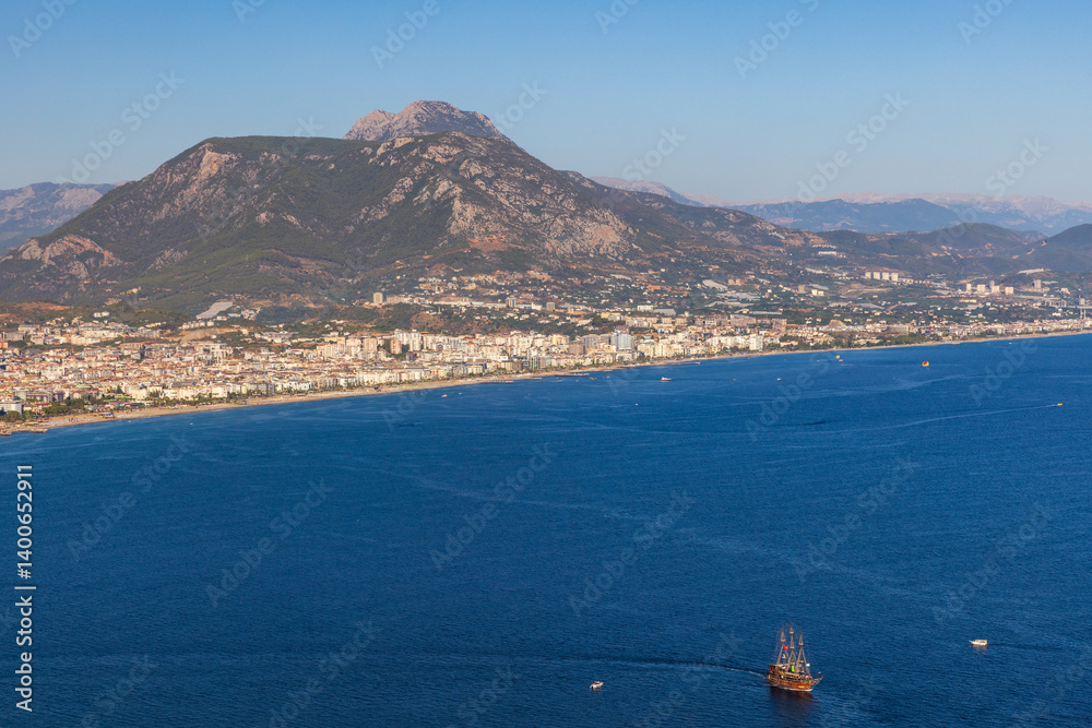 Scenic overlook of a coastal town surrounded by mountains