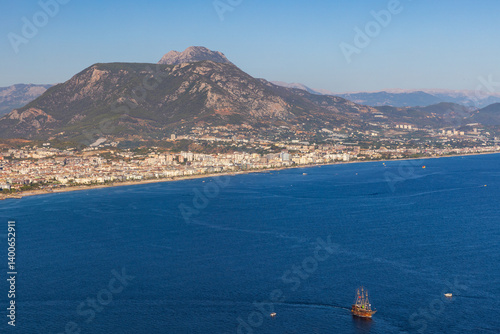 Obraz na płótnie Scenic overlook of a coastal town surrounded by mountains w salonie