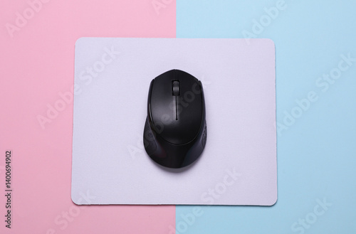 Mockup of white blank computer mouse pad with wireless mouse on blue pink background