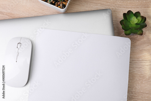 Mockup of white blank computer mouse pad or mat with props, mouse and laptop on table. Top view. Flat lay
