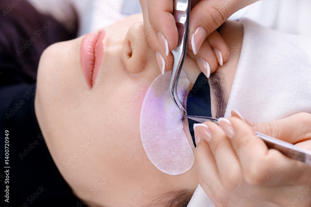 Ultraviolet eyelash extension procedure on young caucasian female, top view