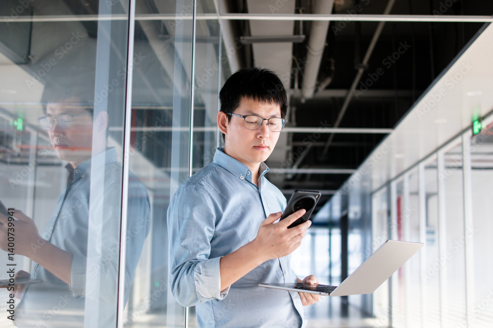 asian businessman working with laptop and smart phone in office asian businessman working with laptop and smart phone in office